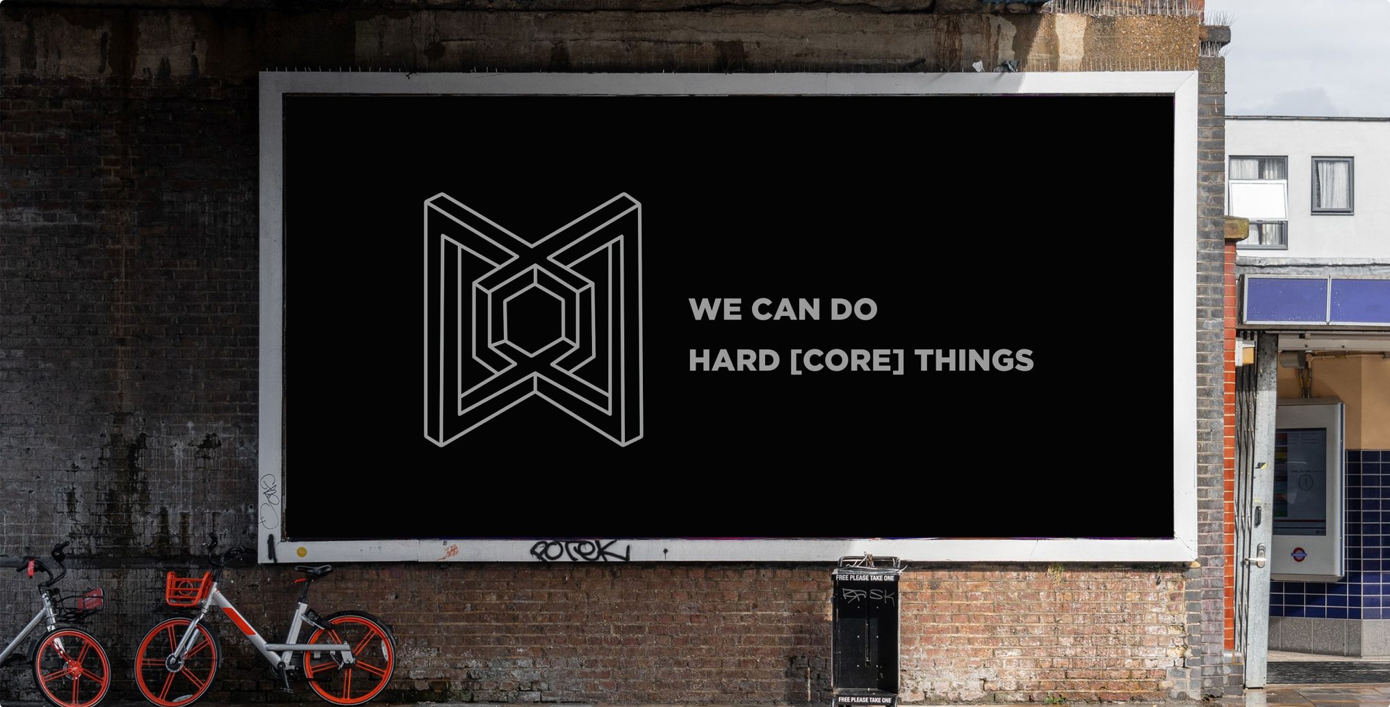 Billboard mockup showing the optical illusion logo and WE CAN DO HARD CORE THINGS type treatment